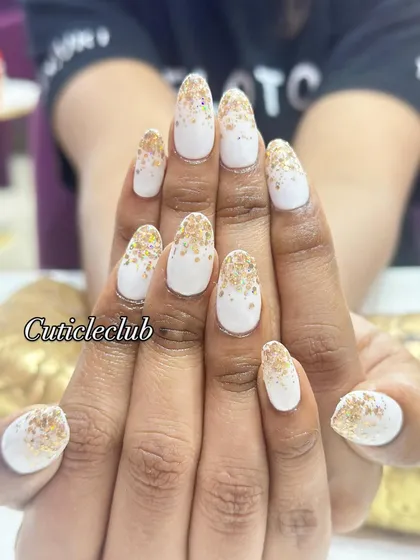 A full view of the white and gold glitter gradient nails, showing how the design looks across both hands.