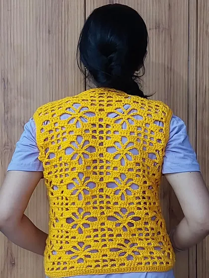 The back of the Argalia Bloom Top features the same beautiful floral filet pattern, ensuring a stunning look from every angle.