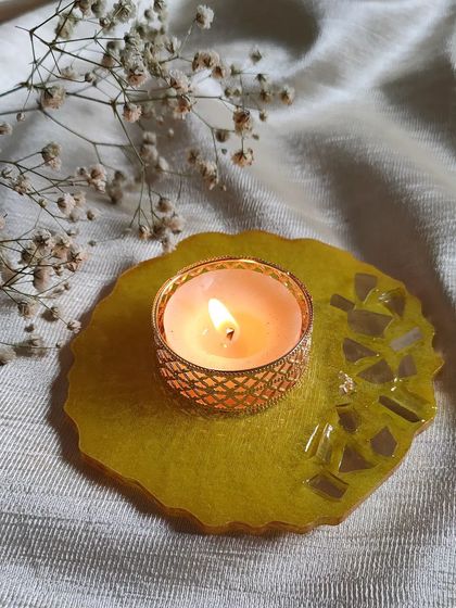 A bright and cheerful yellow T-light holder with mirror accents. This piece is sure to bring a little bit of sunshine to your decor.