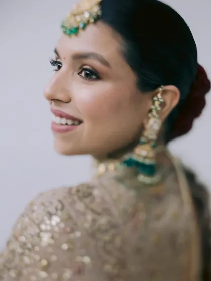 Draped in tradition, glowing like royalty. A close-up of Avika's magical bridal look, focusing on the soft glam makeup that enhances her radiant smile.