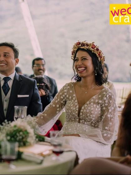 The beautiful bride, Sharon, laughing during her reception. Her floral crown and embroidered dress were perfect for their destination wedding.