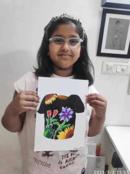 Aarna from the PP2 batch shows off her lovely T-shirt design. She used a dark background to highlight the bright colors of her floral arrangement.