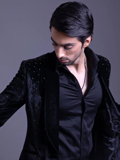 The embellished jacket shown open, revealing the quality of the lining and the overall construction. Effortless elegance is in every detail.