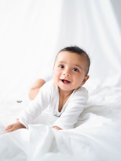 That six-month gummy grin is the best! A classic, clean portrait on a white backdrop for his half-birthday.