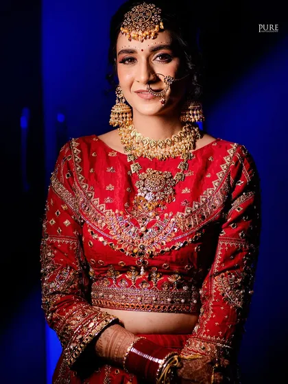 A beautiful bridal portrait with a mix of blue and red light, creating a contemporary feel while showcasing the bride's traditional wedding look.