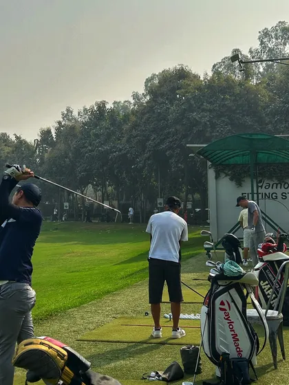 A golfer finishes his swing near our Fitting Studio, a great place to analyze your data and improve.
