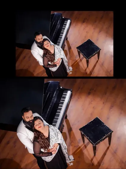 An overhead shot of a couple embracing by the grand piano, offering a unique perspective of the scene. This angle captures the intimacy of the moment beautifully.