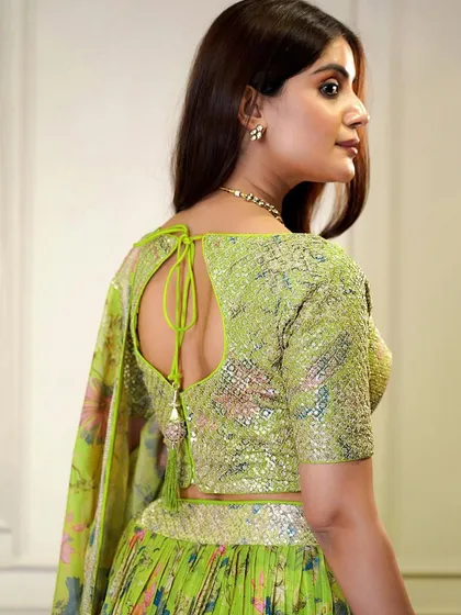 This neon green lehenga is pure energy. The floral organza skirt paired with a sequined blouse makes it a fresh and modern choice for any function.