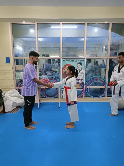 A handshake for a new red belt.
