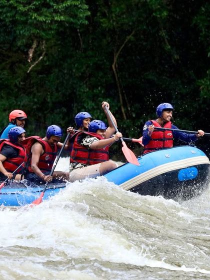 A team works together to power through the white-water rapids at Barapole, Coorg. This dynamic shot highlights the physical and collaborative nature of rafting.