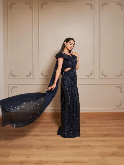 Our Glamour gown is a showstopper. This navy blue sequined dress features a thigh-high slit and a dramatic, flowing trail for a red-carpet-worthy look.