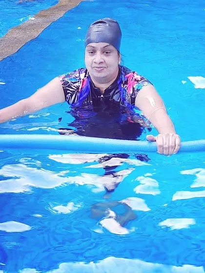 A member uses a pool noodle for support and resistance. This simple tool is incredibly versatile for various water-based exercises that improve core strength and stability.