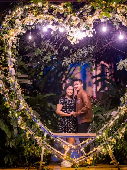 Framed by the heart-shaped light prop, this couple shares a happy moment during their pre-wedding photoshoot.