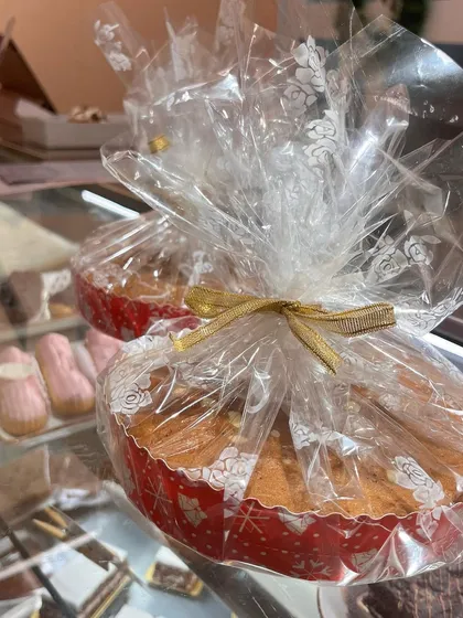 A beautifully wrapped mini cake, perfect as a stocking stuffer or a small Christmas gift. The festive paper and golden ribbon add a special touch.