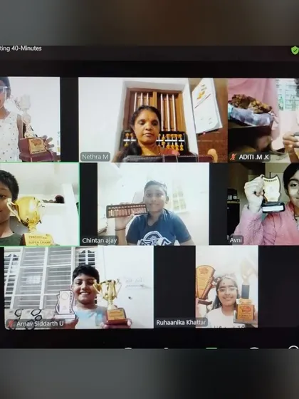 Our online students are achieving great things too. Here they are, proudly showing their trophies and awards during a virtual class session.
