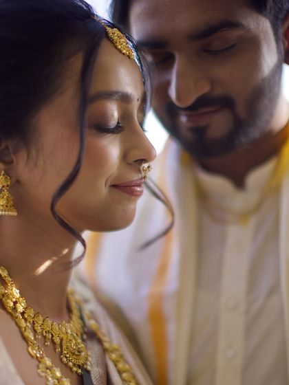 A serene and intimate portrait of the couple with their eyes closed, soaking in the moment. The soft sunlight adds a beautiful glow.