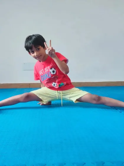 Full of energy and enthusiasm, a young student shows off his split. Our goal is to make our Dojang a place where kids love to train and grow.