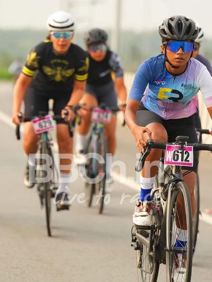 A female rider from the Racefit Coaching team, focused and determined.