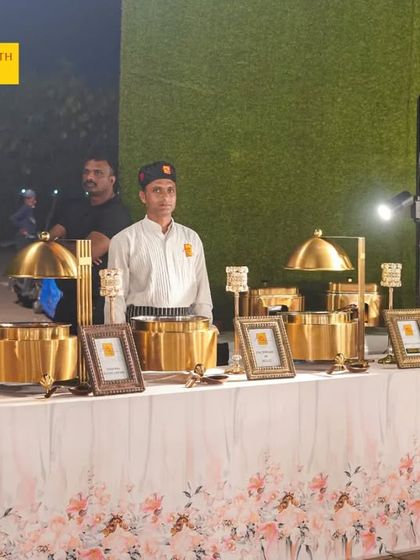 Experience culinary excellence with our royal food counters. This Mughlai and Moghal Station is set up with authentic brass serving pots and elegant signage, transporting your guests to an era of royal feasts.