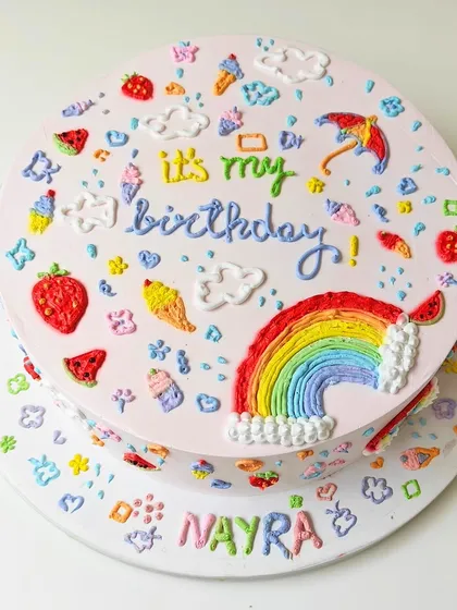 This two-tier doodle cake is a canvas of memories, hand-piped with colorful buttercream doodles that tell a personal story. It’s a completely fondant-free design, perfect for those who love artistic details and a creamy texture. I work with you to include doodles that are meaningful to your celebration.