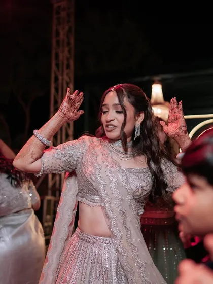 Another shot of the bride having fun on the dance floor. Her glamorous makeup and hairstyle stay perfectly in place.
