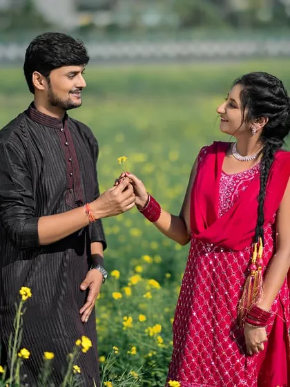 A classic Bollywood-style moment in a field of yellow flowers. The groom offering a flower to his bride is a timeless gesture of romance, made even more beautiful by their traditional outfits.