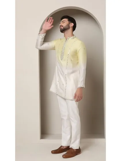 A side view of the Zesty Leamon kurta, highlighting its modern asymmetric cut and the sparkling mirror work.