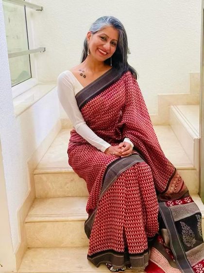 Another look at this comfortable and chic red printed saree, perfect for feeling stylish at home.
