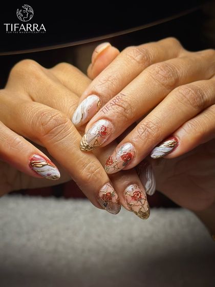 Where delicate florals meet molten gold. This set combines hand-painted red roses with abstract gold chrome and white marble effects on long almond extensions.