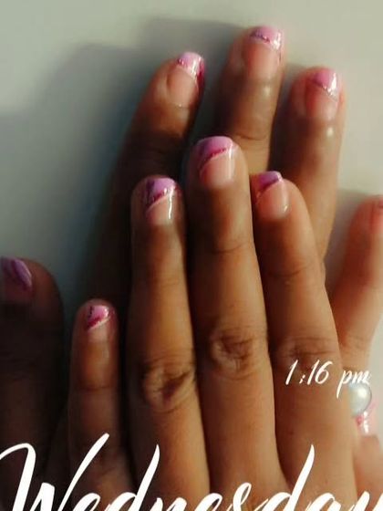 A creative design with abstract pink swirls and a fine silver glitter line on short nails.