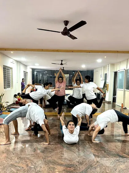 A fun and dynamic group pose in front of the studio mirror. This photo captures the joy, strength, and creativity that we bring to our practice every day.