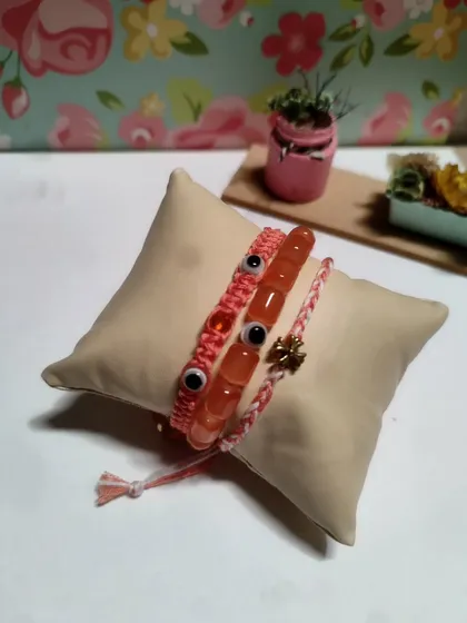 My collection of handmade bracelets, available in many colors and styles. I use beads, evil eye charms, and macrame techniques to create these stackable pieces.