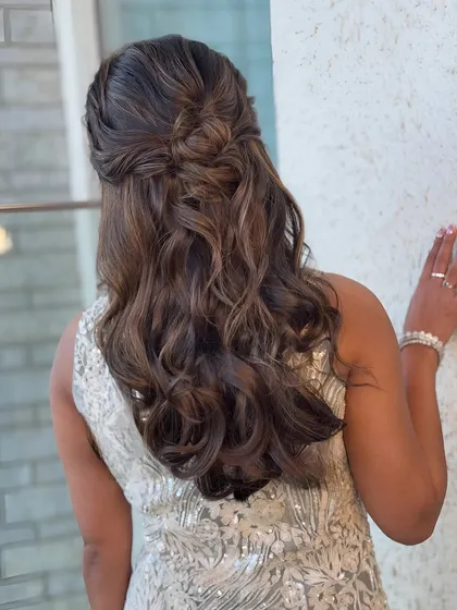 Another angle of the knotted half-updo, showing how it complements the client's sequined outfit.