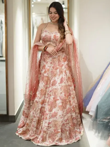 A beautiful floral lehenga in soft pastel shades. The delicate print and sparkling details make it a romantic choice for any festive occasion.