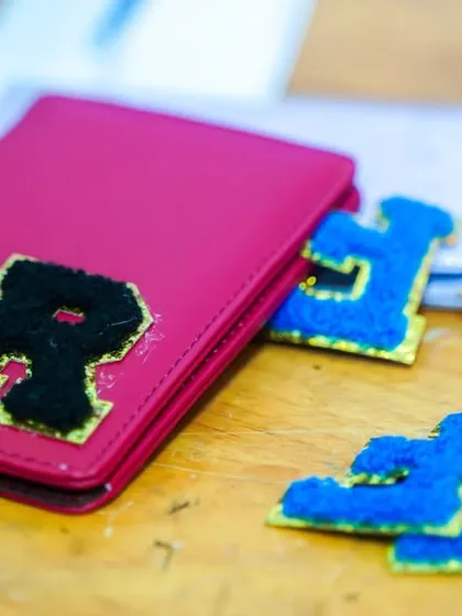 A creative activity station where guests can personalize passport holders with their initials.
