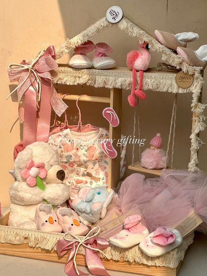 A full view of my 'Pretty in Pink' keepsake wardrobe. This house-shaped display is a beautiful way to gift clothes, shoes, and toys, and later becomes a charming decor piece for the nursery.