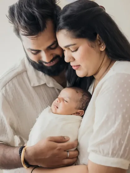 A tender moment with parents holding their swaddled newborn close. The love in this photo is so clear.