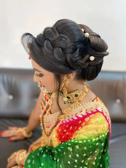 A side view of the braided and knotted bun, showing how the elements are combined to create a high-volume, textured updo suitable for a bride or wedding guest.