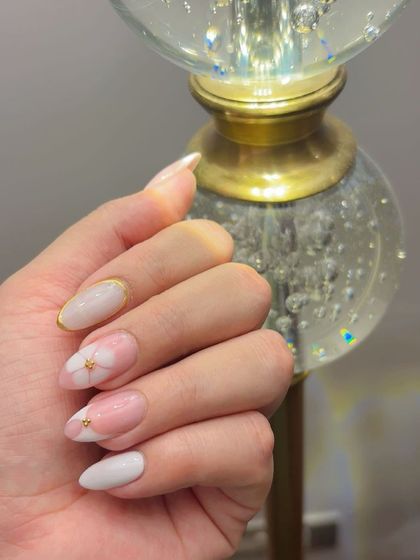 The blossom gel nails looking extra sparkly against a crystal lamp.