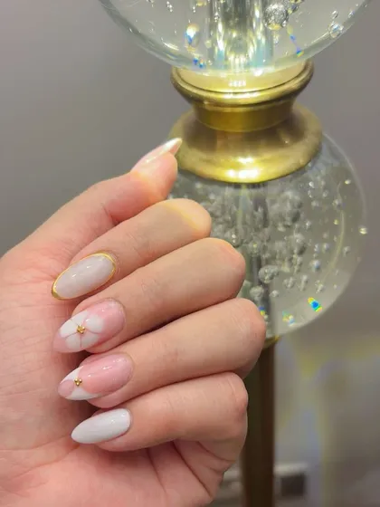 The blossom gel nails looking extra sparkly against a crystal lamp.