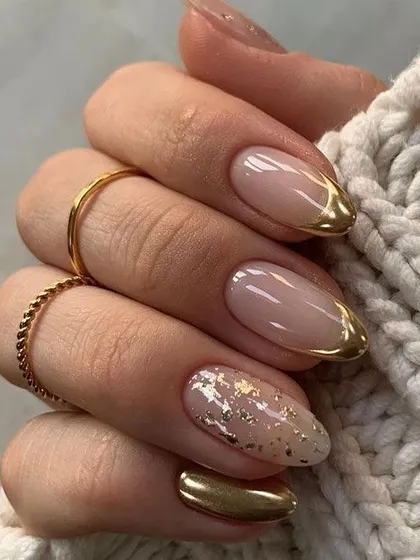 A chic and trendy set featuring a neutral base with gold foil accents and gold chrome French tips.