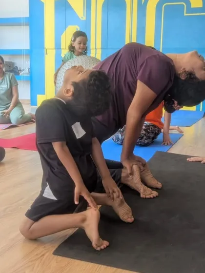 A student and I practicing a backbend together. Partner stretches can help improve flexibility and build trust.