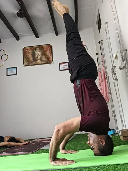 A side view of a headstand, showing the straight line from the shoulders to the hips and ankles that we aim for.