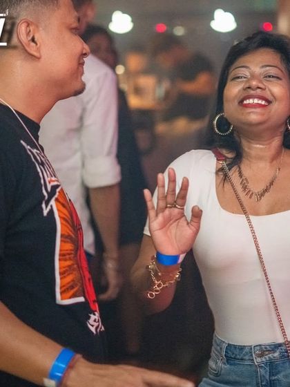 A candid moment of laughter and joy on the dance floor.