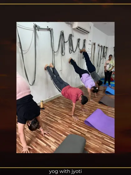 Students practicing handstand variations against the wall to build upper body power and endurance.