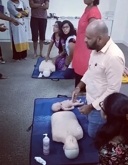 An instructor demonstrates the correct procedure for infant CPR, a specialized and vital skill.