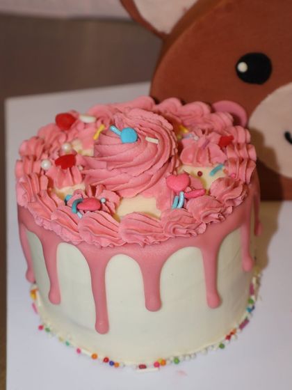 Another look at the adorable pink drip cake that accompanies our half birthday bear cake, because every celebration deserves a little extra sweetness.