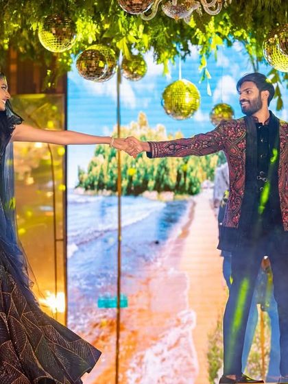 A stunning shot of the couple during their romantic duet. The LED screen backdrop and their connection create a picture-perfect moment.