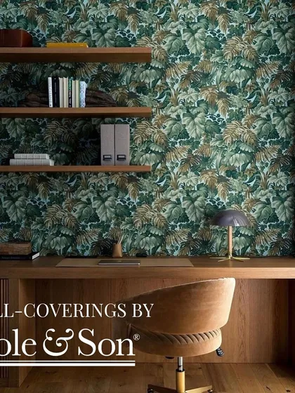 Wallcoverings by Cole & Son offer timeless elegance. This study, adorned with a dense botanical print, creates a sophisticated and inspiring environment, perfect for work or relaxation.