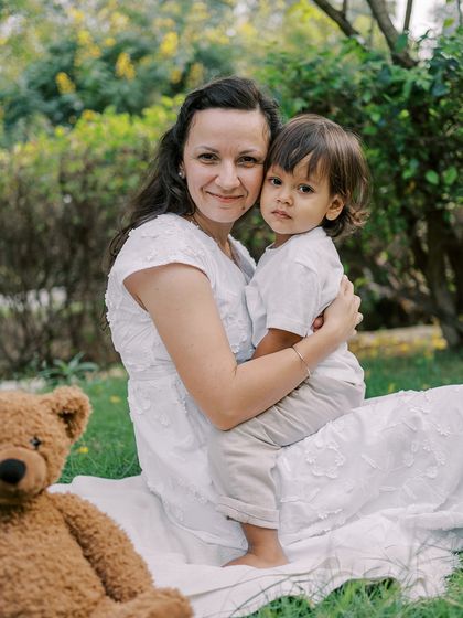 A mother holding her son, who is looking a bit shy. It's important to capture all their little expressions.